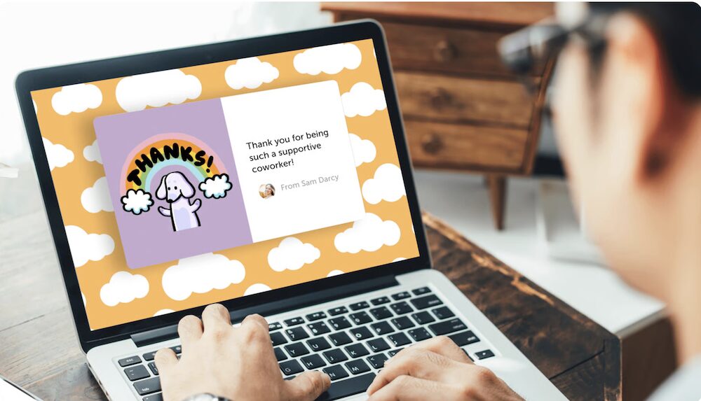 A person viewing an ecard on a laptop screen